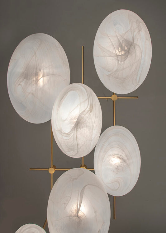 Modern chandelier with marble-like lampshades on a gray background