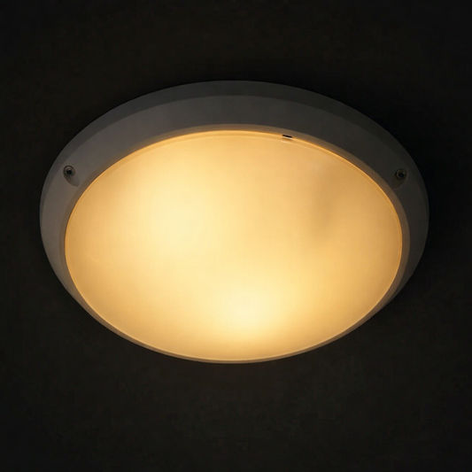 Round ceiling light fixture with a warm glow on a black background