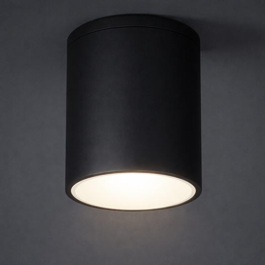 Black cylindrical ceiling light fixture on a dark gray background