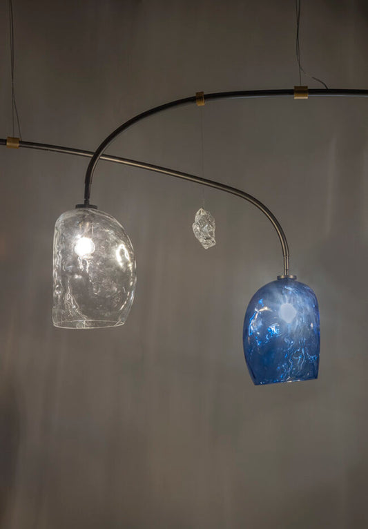 Modern chandelier with glass shades on a gray background