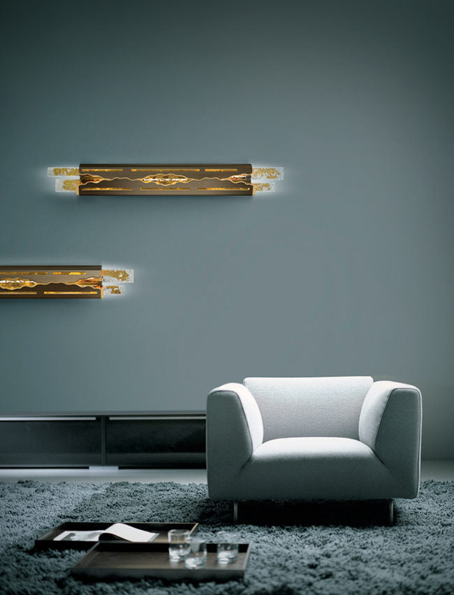 Modern living room with a gray armchair, coffee table, and wall lights.