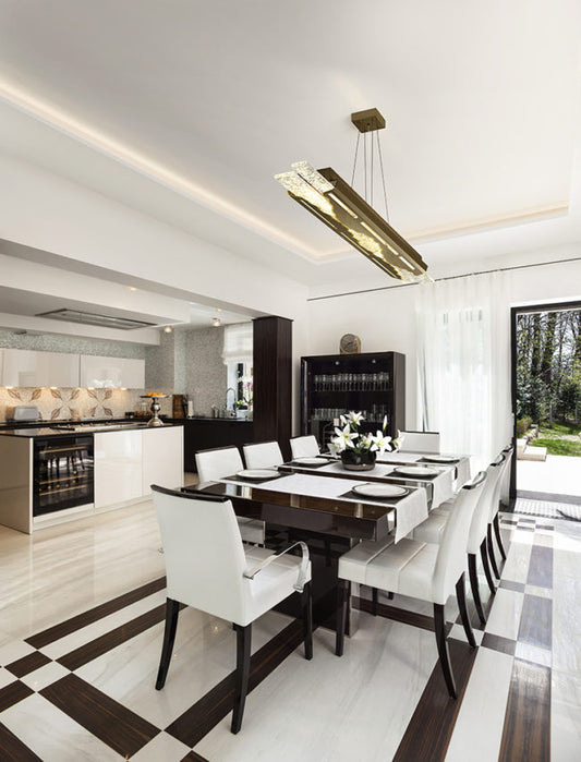 Modern kitchen with a dining table and chairs, featuring a stylish pendant light.