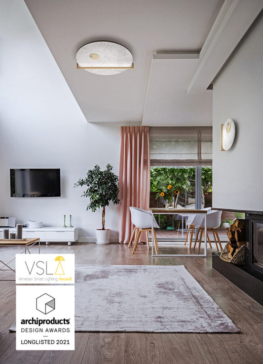 Modern living room with ceiling light fixture, archiproducts design awards logo.