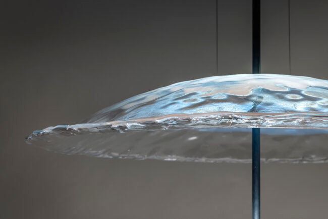 Close-up of a transparent, textured object on a dark background
