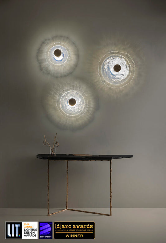 Modern wall lights with a minimalist table and 'd'arc awards' logo on a gray background