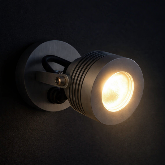 Wall-mounted light fixture with a glowing bulb on a dark background
