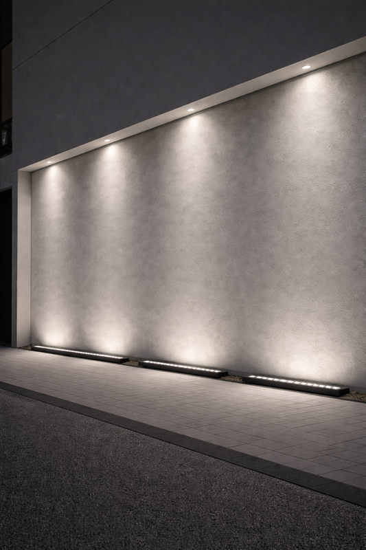 Modern outdoor setting with a textured wall illuminated by linear lights.