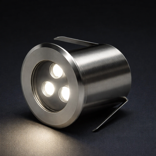 Metallic outdoor light fixture on a dark background