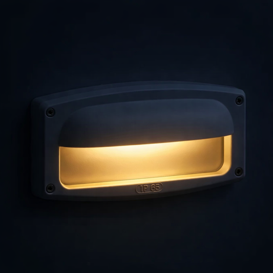 Wall-mounted light fixture emitting a warm glow against a dark background