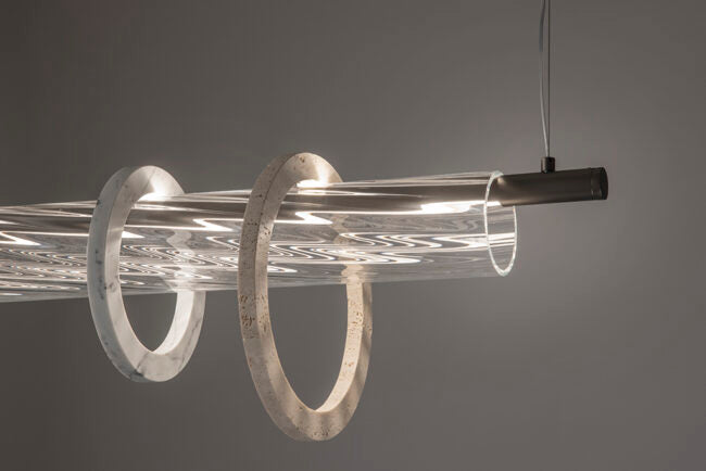 Modern pendant light with circular design on a gray background