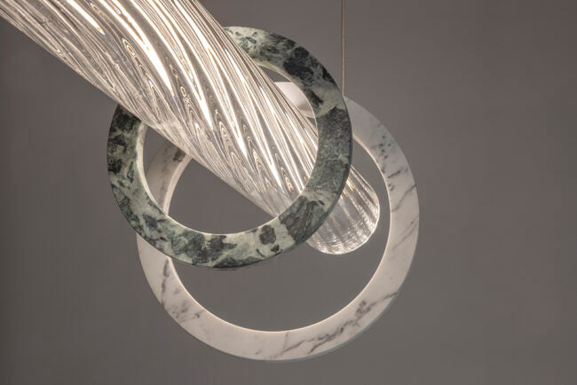 Decorative ring with marble texture and metallic sheen on a gray background