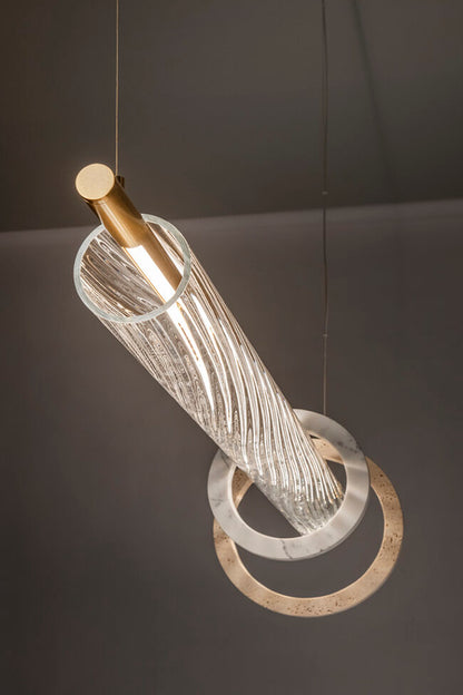 Modern pendant light with glass and metal design on a dark background