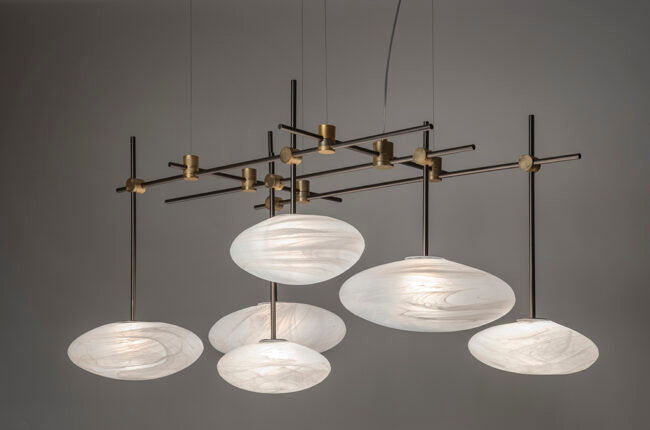 Modern chandelier with glass shades on a gray background