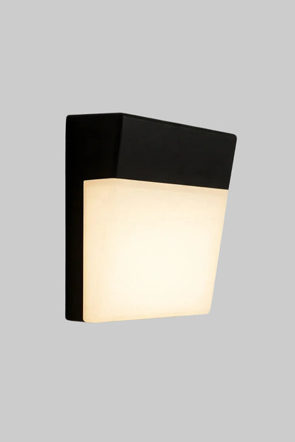 Black wall-mounted light fixture on a gray background
