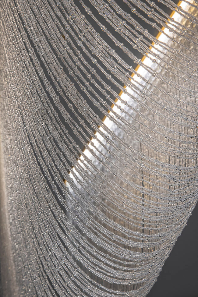 Close-up of a textured silver surface with reflective patterns