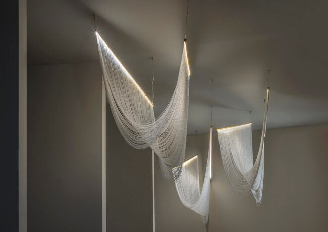 Hanging fabric art installation in a minimalistic room
