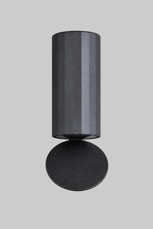 Black cylindrical wall light fixture on a white background