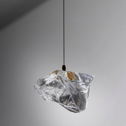 Clear crystal pendant light against a gray background