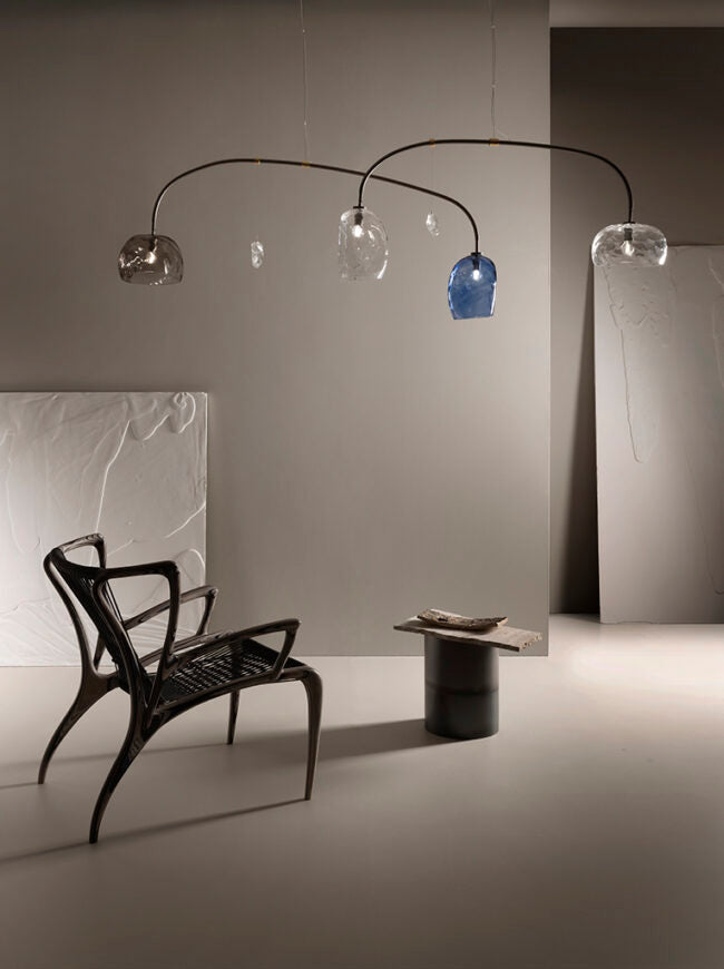 Modern floor lamp with glass shades in a minimalistic room.