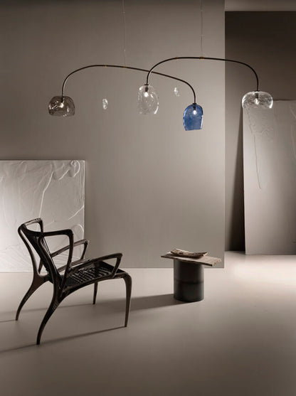 Modern floor lamp with glass shades in a minimalistic room.