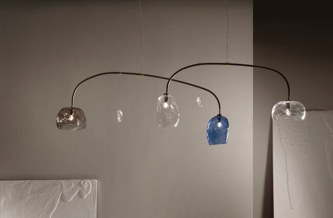 Modern chandelier with glass shades on a neutral background