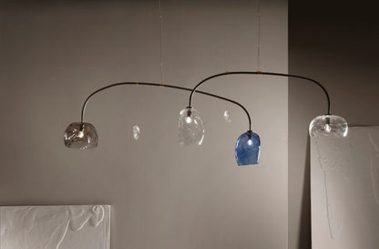 Modern chandelier with glass shades on a neutral background