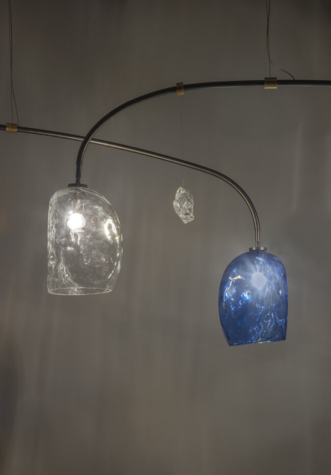 Modern chandelier with glass shades on a gray background