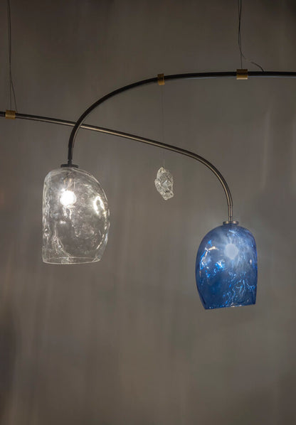 Modern chandelier with glass shades on a gray background