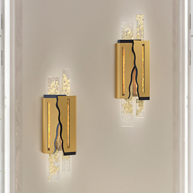Two modern wall sconces with gold and glass design on a neutral wall.