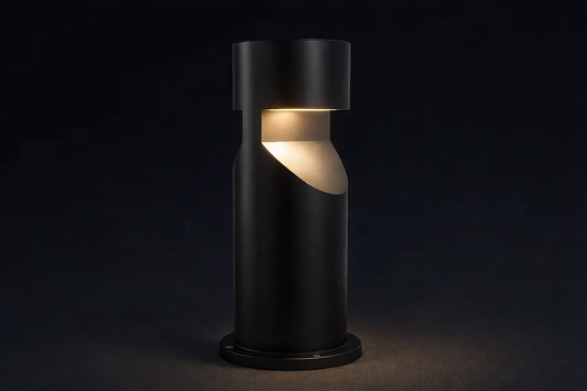 Modern black outdoor lamp with a warm light on a dark background
