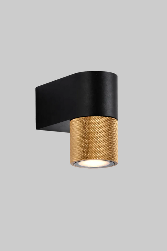 Modern wall light fixture with black and gold design on a white background