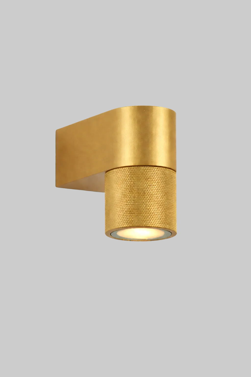 Gold wall-mounted light fixture on a white background
