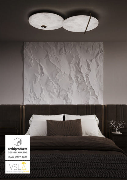 Modern bedroom with textured wall and ceiling light fixture, featuring Archiproducts and VSLA logos.