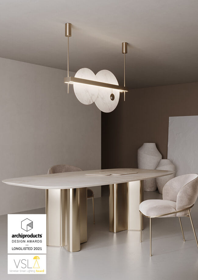 Modern dining room with a stylish table and chairs, featuring Archiproducts Design Awards logo.
