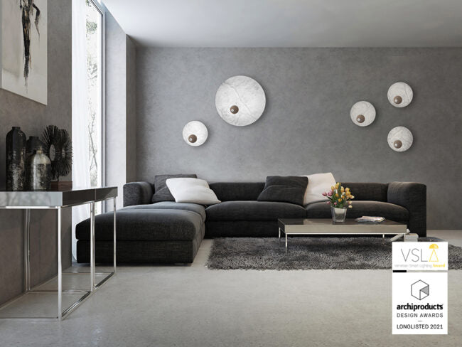 Modern living room with a gray sectional sofa, coffee table, and decorative items.