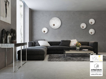 Modern living room with a gray sectional sofa, coffee table, and decorative items.