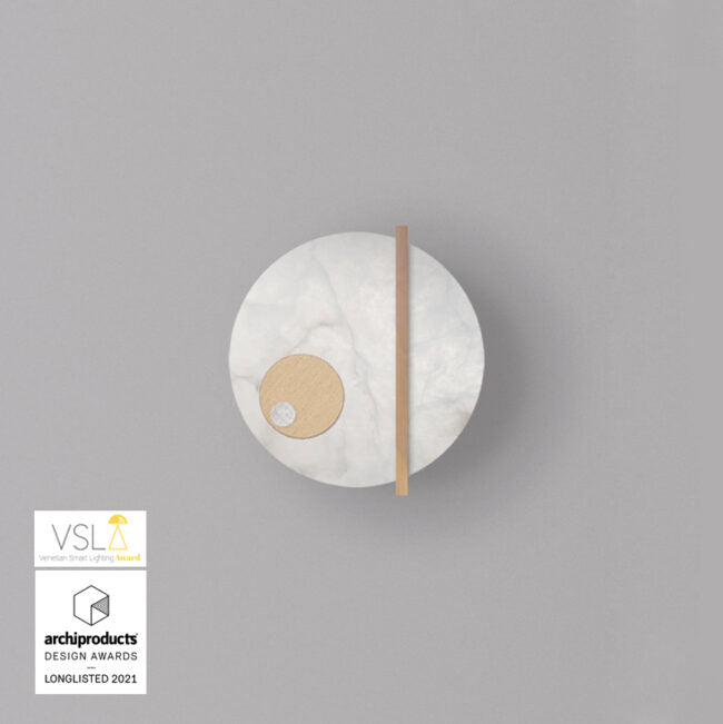 Round wall light fixture on a gray background with VSLA and archiproducts Design Awards logos.