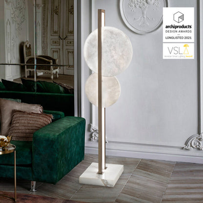 Modern floor lamp with marble base in a stylish room setting, featuring archiproducts Design Awards 2021 logo.