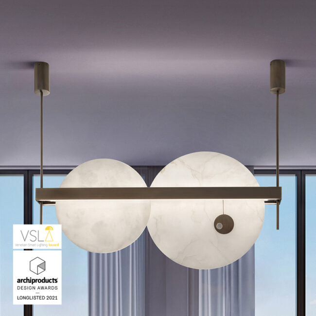 Modern pendant light fixture with spherical glass shades in a room with large windows.