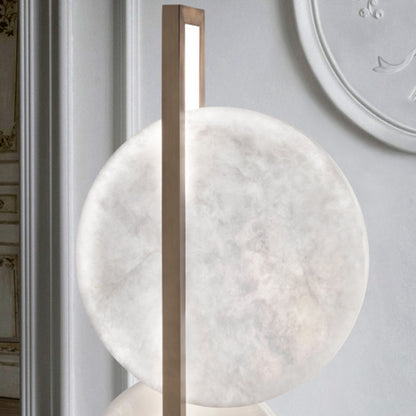 Decorative wall art with marble-like finish and wooden frame on a light gray wall.