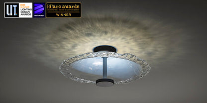 Ceiling light fixture with awards logos on a dark background