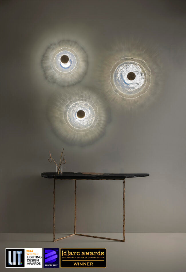 Modern wall lights with a minimalist table and 'd'arc awards' logo on a gray background