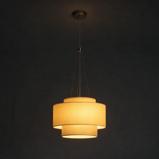 Pendant light with three cylindrical shades on a dark background